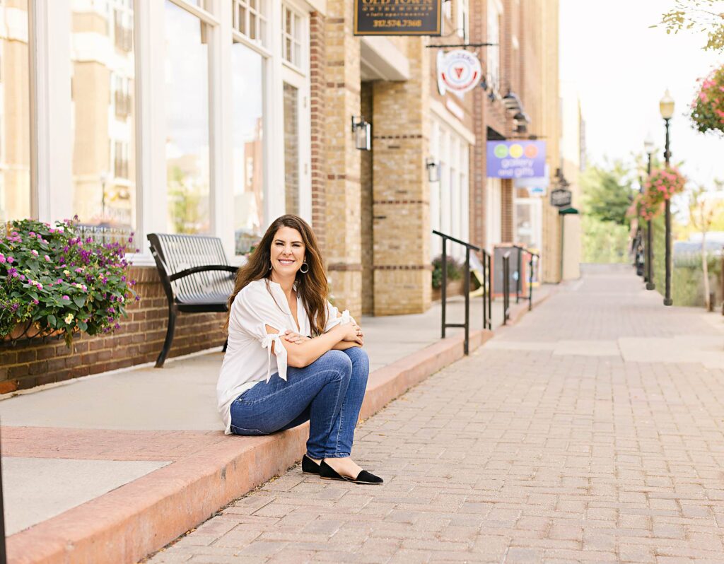 Indianapolis Realtor Stacy Barry sitting outside along the street in Carmel, Indiana