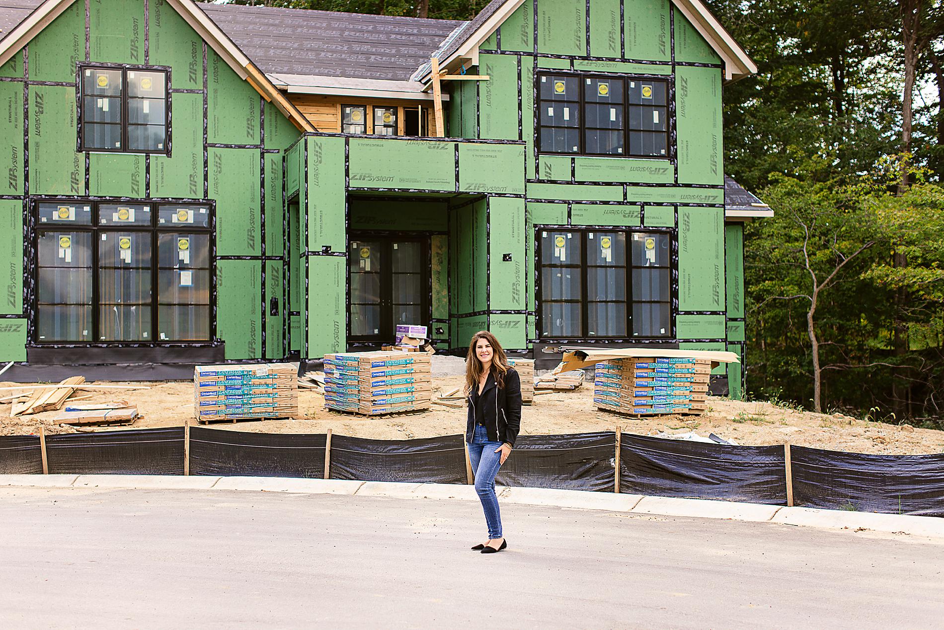 Best Carmel Realtor, Stacy Barry, standing in front of a new construction home